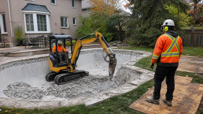 Crew removing an inground concrete swimming pool